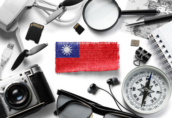 Flag of Taiwan and travel accessories on a white background.