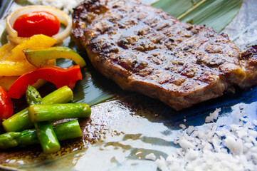 Sirloin steak ready to eat in a delicious plate with grilled vegetables