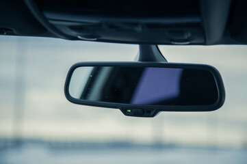 Poster - Closeup shot of a car mirror on a blurred background