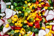 Salad with radishes, green onion, red pepper and corn kernels.