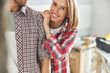 © Svitlana - Pleased young woman and her husband posing in their new apartment