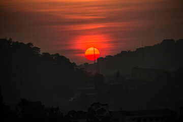 Wall Mural - dramatic summer sunrise in Mines View Park  in the Summer Capital of the Philippines , Baguio City.