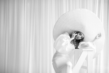 Wall Mural - Young woman in large wide brimmed hat