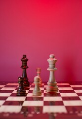 chess pieces and glossy chessboard. close up and blurry view