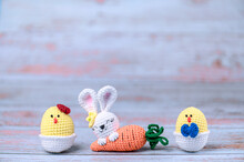 . Easter Knitted Bunny On A Blue Wooden Background. Easter Postcard. Happy Easter