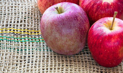 Closeup of red ripe apples on a reticulate surface