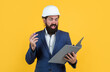 © be free - working on project. building concept. builder or engineer in hard hat. surprised mature architect in helmet making notes. brutal bearded man work on construction site with documents