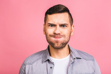 Young handsome caucasian man in casual isolated over pink background puffing cheeks with funny face. Mouth inflated with air, crazy expression.