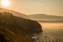 USA, California. Big Sur, Sunrise Looking South Along Foggy Coastline.