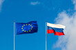 EU flag and Russia flag are on blue sky. Concept relations between Europe and Russia