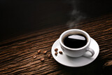Fototapeta Mapy - Top view of cup of coffee with smoke and coffee beans on old wooden background.