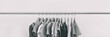 Clothing rack of women's closet organizing clothes for spring cleaning or fashion store outlet sale. Panoramic black and white style banner.