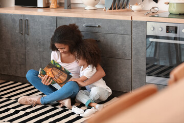 Sticker - Cute African-American sisters reading book at home