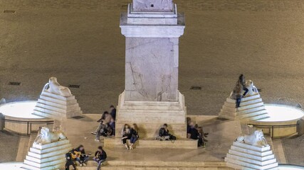 Wall Mural - People are gathering under the central column on piazza del popolo during night timelapse. Top aerial view from the Pincio Landmark