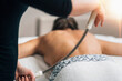 © Microgen - Body Shaping Back Massage Treatment with a Metal Rolling Pin