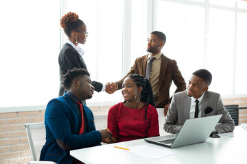 Sticker - team of young african people in the office at the table with a laptop 