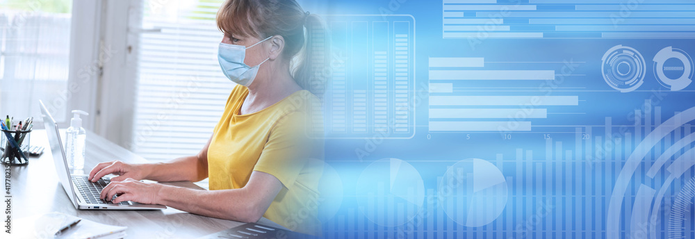Fotografia Businesswoman with medical face mask and working on laptop from home; panoramic