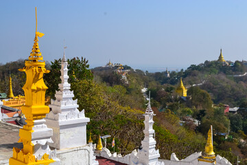 Wall Mural - Mesmerizing view of Sagaing Hill with Buddhist temples and trees under the clear sky in Myanmar