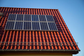 Photovoltaic system on the red tile roof, old version from 2005, 2.4 kWp, renewable energies