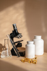 Wall Mural - Laboratory for the creation and study of tablets. Omega 3 capsules. Chemical equipment, flasks and measuring cups. Top Hero. 
Pills from quality raw materials