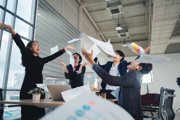 Wall Mural - Team of LGBT business people throws paper in joy of meeting their goals, achievements, achievements. LGBTQ business team concept, jumping to celebrate Asian ethnic success.