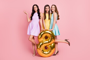 Sticker - Photo of three adorable sweet young girlfriends wear colorful outfits smiling holding golden eight number isolated pink color background