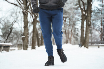 Wall Mural - Jogger man running in winter city park