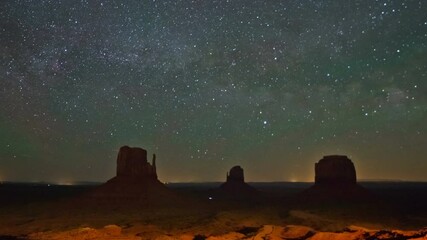 Wall Mural - night time lapse landscape with stars in monument valley, usa