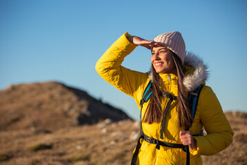 Happy female mountaineer sightseeing in nature