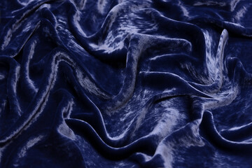 Wall Mural - Luxurious waves of dark blue velvet fabric background.
