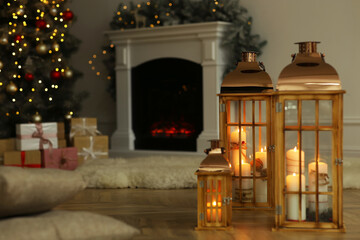 Canvas Print - Christmas lanterns with burning candles in decorated living room. Space for text