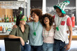 Diverse group of friends celebrating st patrick's day embracing and laughing at a bar