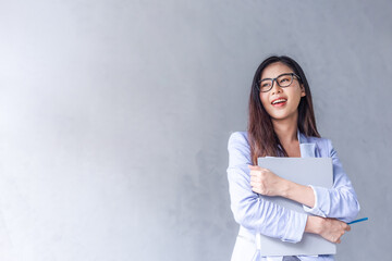 beautiful business woman wears glasses to be a happy asian smile in the mobile, the file is in the o