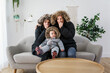 Couple have cold on the sofa at home with winter coat with baby