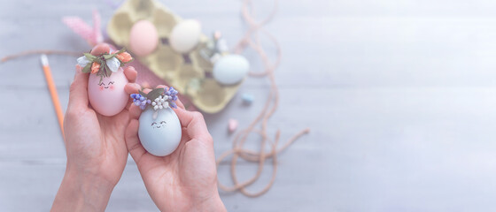 Wall Mural - woman makes cute decorative eggs for easter holiday. do-it-yourself easter gifts concept. cute pastel colored eggs