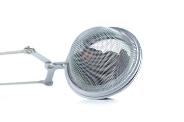 Canvas Print - Metal tea strainer with tea leaf on white background isolation