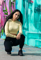 Wall Mural - pretty young girl sitting on the street