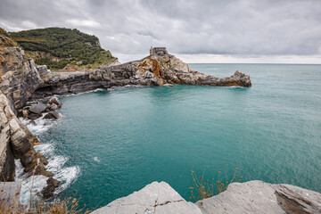 Portovenere (Porto Venere) in Liguria, Italy: beautiful aerial scenic view of the Church of St. Peter (Chiesa di San Pietro) from Doria castle nearby Cinque Terre