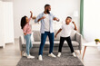 © Prostock-studio - African american dad dancing to music with his little children