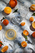 oranges and clementines vitamin juice on light blue table