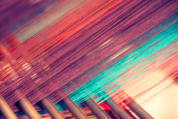 multicolored straight strands texture background, sewing equipment, loom equipment at a garment fact