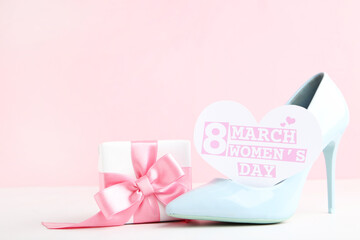 Canvas Print - Card in shape of heart with text 8 March Womens Day, gift box and blue high-heeled shoe on pink background