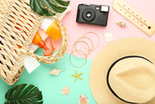 Summer Straw Hat With Retro Camera, Starfishes, Monstera Leafs And Moisturizing Creams On Colorful Paper Background