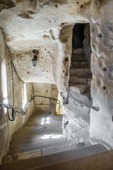 Wall Mural - Inner passage inside ancient cave Christian monastery. There are stairs carved in rock, walls with paths of hand work