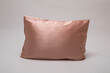 Silk pillow on gray background, soft luxury cushion