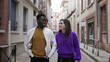 © Marco - Young interracial couple walking together, modern millennial boyfriend and girlfriend in street