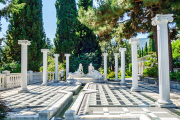 Wall Mural - Old fountain statues of two lovers & colonnade in urban public park Paradise (sanitarium Aivazovsky) in Partenit, near Alushta, Crimea