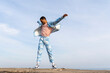 © VISTA by Westend61 - Carefree man dancing with arms outstretched against sky