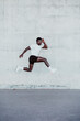 © VISTA by Westend61 - Sportsman jumping by white wall