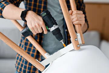 Wall Mural - Repairman, carpenter and handyman working at home with tools or hobby during covid-19 epidemic